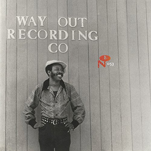 Black and white album cover featuring a smiling man in a patterned shirt.