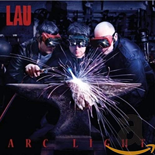 "Album cover: three men welding with sparks, wearing protective masks, in a workshop."