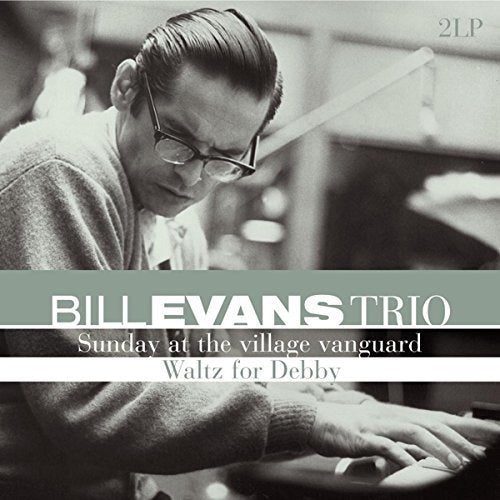 Black and white image of Bill Evans playing piano with album title text overlay.