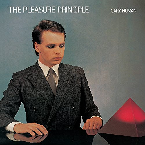 Gary Numan album cover: man in suit, red pyramid, blue background.