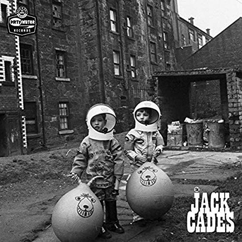 Black and white photo of two children in space helmets with bouncing balls.