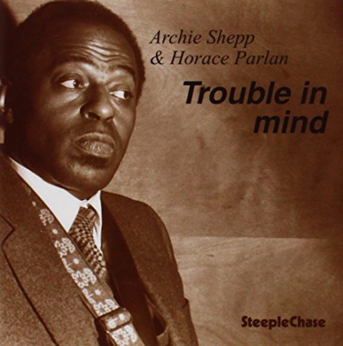 "Album cover featuring sepia-toned photo of Archie Shepp in a suit and tie."