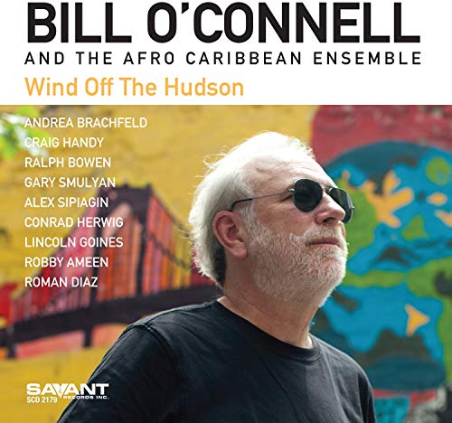 "Album cover featuring a man with white hair and sunglasses against a vibrant, abstract background."