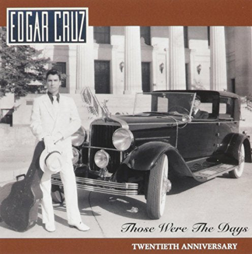 "CD cover featuring a man in white suit beside a vintage car."