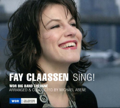 "CD cover featuring a smiling woman with dark hair and overlaid text."