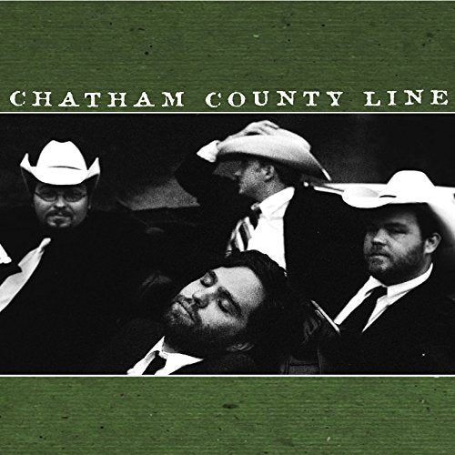 "Album cover with four men in cowboy hats and suits on a green background."