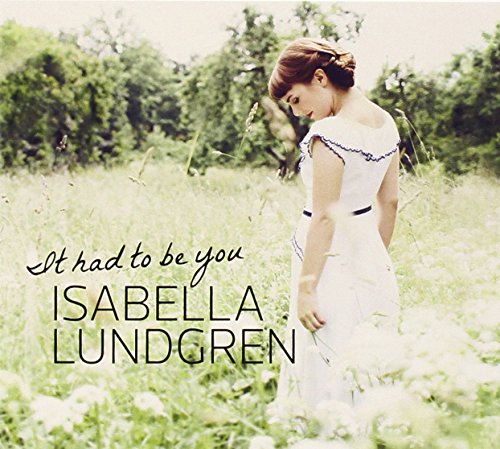 "Album cover with a woman in a white dress standing in a field."