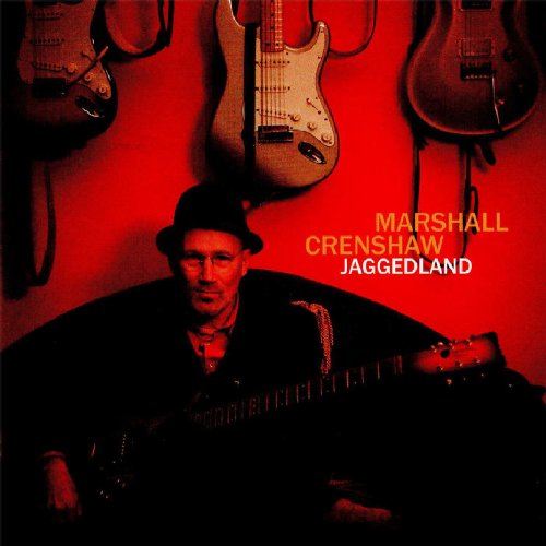 "Album cover featuring Marshall Crenshaw holding a guitar, surrounded by guitars on a red wall."