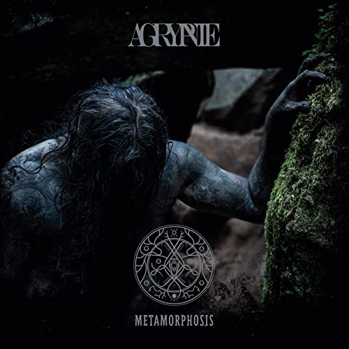 Vinyl album cover: shadowy figure with tattoos emerging from mossy stone.