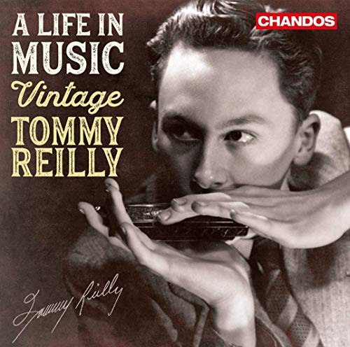 Black and white portrait of Tommy Reilly playing a harmonica.