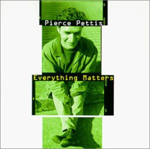 "Album cover featuring a man crouched down, with green-tinted images and text overlays."