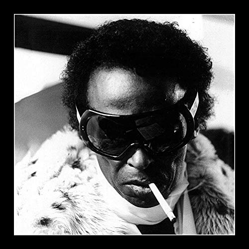 "Black and white album cover with a man wearing sunglasses and smoking a cigarette."