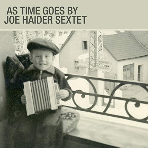 "Album cover with a boy holding an accordion on a balcony."