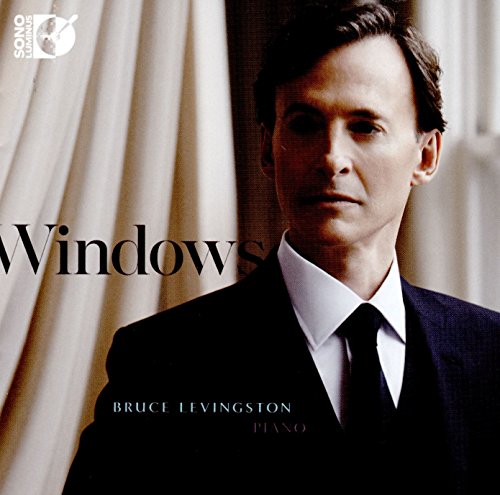 Man in a black suit and tie, piano album cover with "Windows" title.