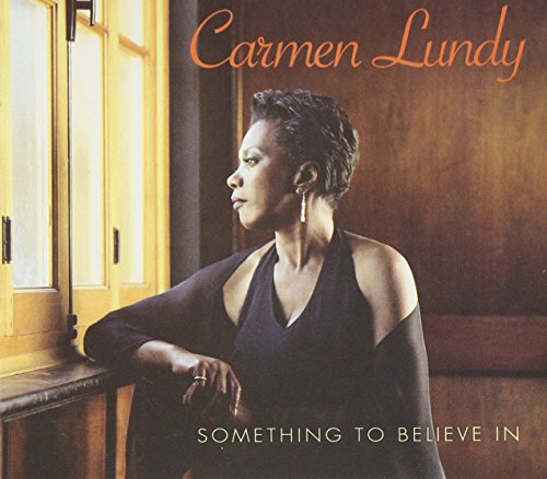 "Album cover with a woman in black leaning on a windowsill, looking outside."