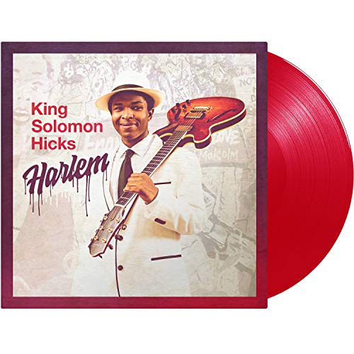 Red vinyl record with album cover featuring a man holding a guitar.