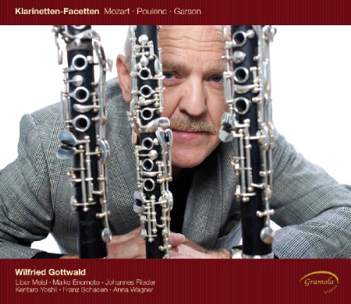 Man holding three clarinets, wearing a grey suit, on a classical music CD cover.