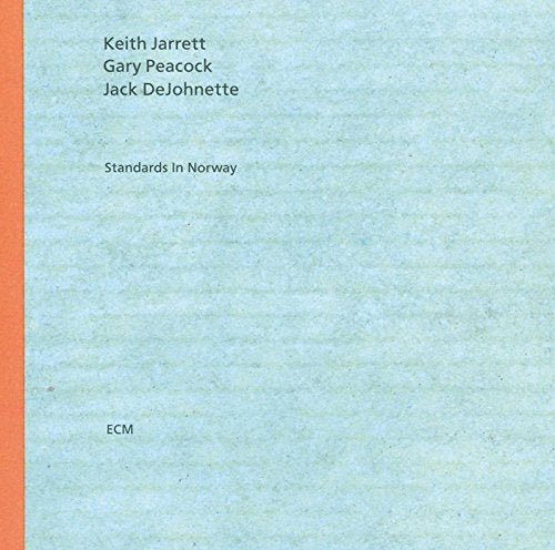 "Light blue album cover with orange stripe and black text listing the artist names."