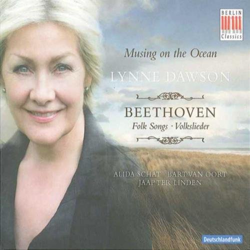 "CD cover featuring a smiling woman with a cloudy sky and grassy field."