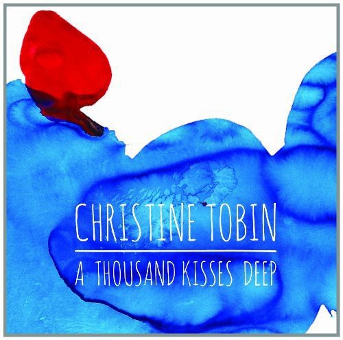 Album cover with blue watercolor design, red splash, and white text "Christine Tobin A Thousand Kisses Deep".