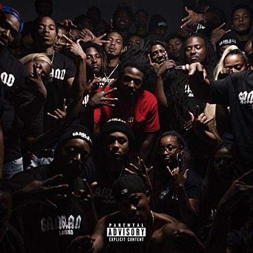 Group portrait of people in dark clothing, with a parental advisory label.