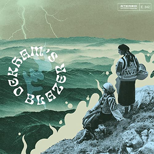 Vinyl record cover with two figures in traditional clothing, misty mountains.