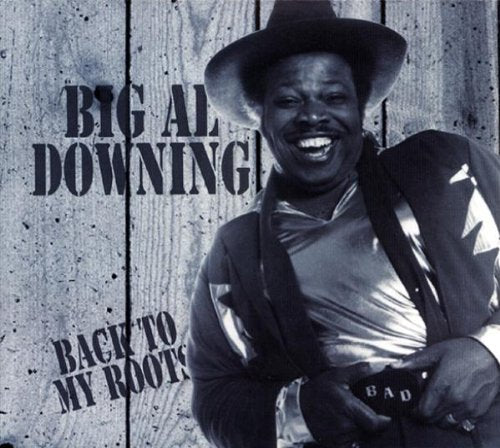 Big Al Downing smiling, wearing a cowboy hat and western attire.