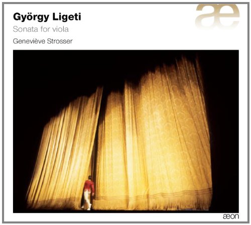 CD cover with a person standing between large, lit yellow curtains on a dark stage.