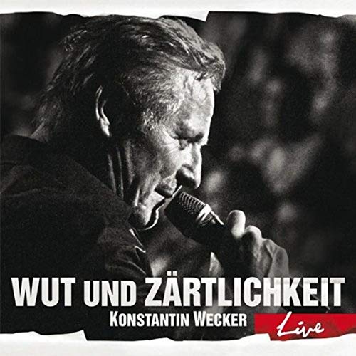 Black and white portrait of Konstantin Wecker singing into a microphone.