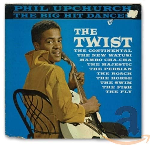 "Vintage vinyl record cover with a man holding a guitar against a blue background."