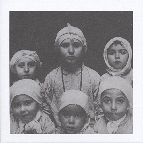 Black and white photo of five children in head coverings.