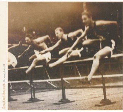Sepia-toned image of four men sitting on hurdles, wearing athletic attire.