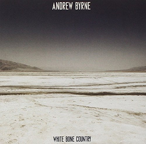 "Album cover with a dry, cracked landscape and darkening sky, titled 'White Bone Country'."