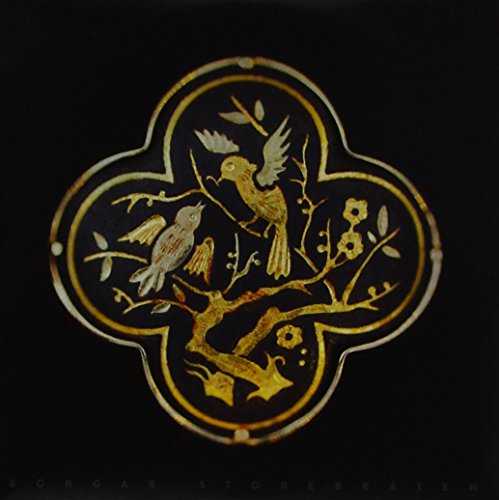A CD case featuring a gold, four-leaf clover design with birds on a branch.