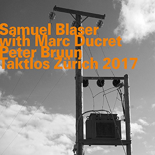 "Album cover with black and white utility pole image and orange text."