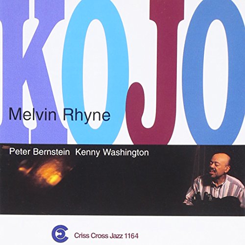 "CD cover with 'KOJO' in large letters, featuring a man playing an organ."