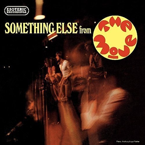 "CD cover with a band performing on stage, blurry and dark background."