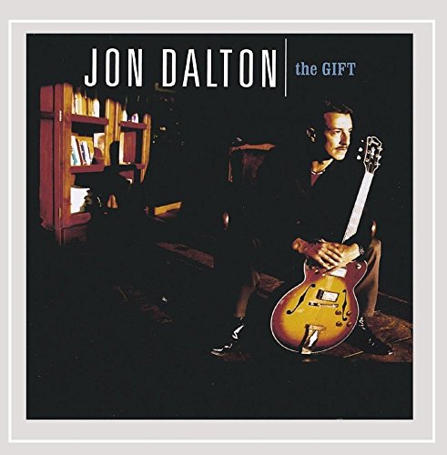 Album cover for Jon Dalton’s “The Gift” featuring a man with a guitar.
