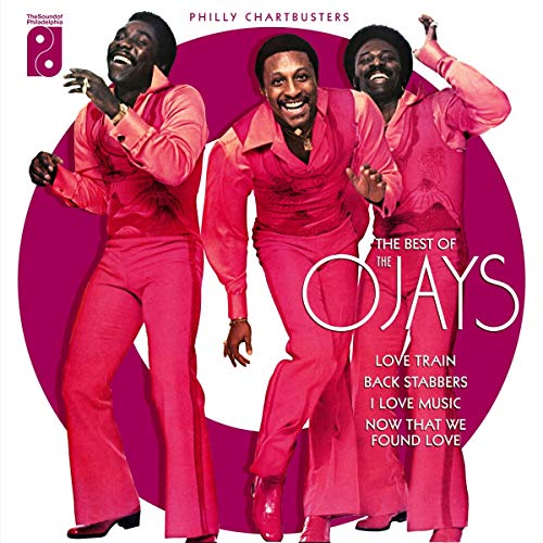 The image shows a vinyl record cover with three men in red suits.