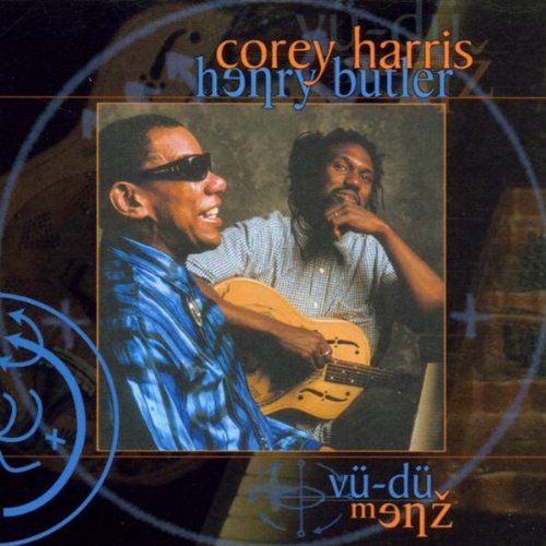 "CD cover with two men, one playing guitar, against a dark background with blue symbols."