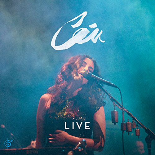 Album cover with a woman singing into a microphone on a blue-lit stage.
