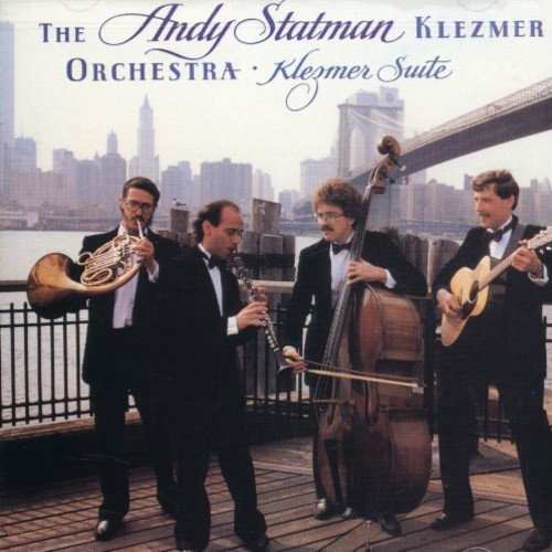 "CD cover featuring four musicians in tuxedos playing instruments on a wooden deck."