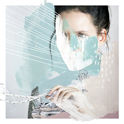 A woman's face is partially obscured by abstract, dripping paint on a vinyl album cover.