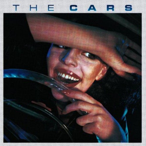 "Album cover of 'The Cars' featuring a woman biting a car gearshift."