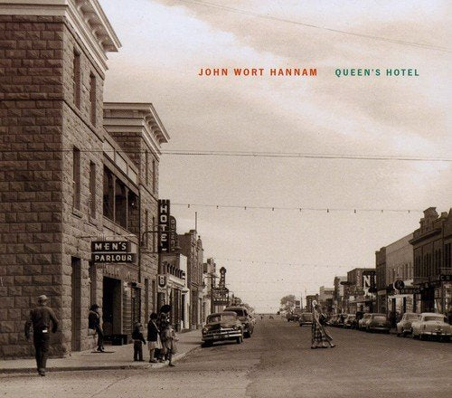 "Black and white album cover with vintage street scene and artist's name."