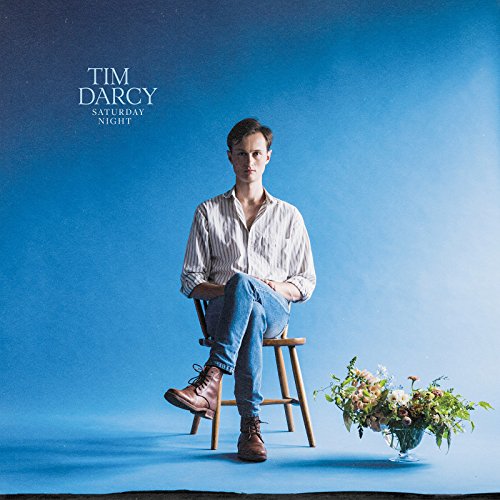 Album cover for Tim Darcy’s “Saturday Night” featuring a man and flowers.