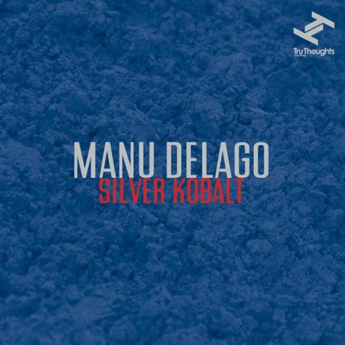 The image depicts a blue textured background with white and red text. The alt text is: "Blue textured album cover with 'Manu Delago Silver Kobalt' in white and red."