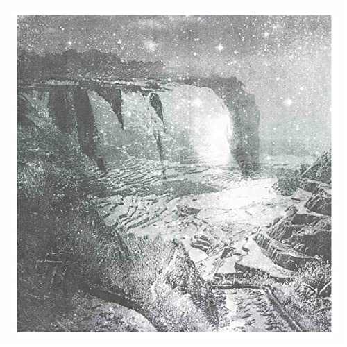 Grainy black and white landscape with a natural stone archway.