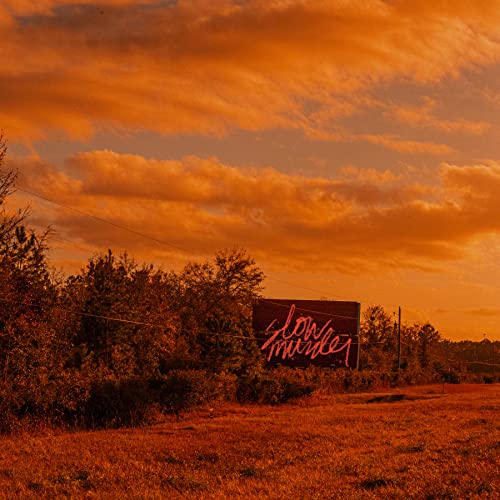 Orange sunset landscape with a sign reading "slow murder" in script.
