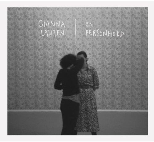 Black-and-white album cover with two women standing in front of a patterned wallpaper.